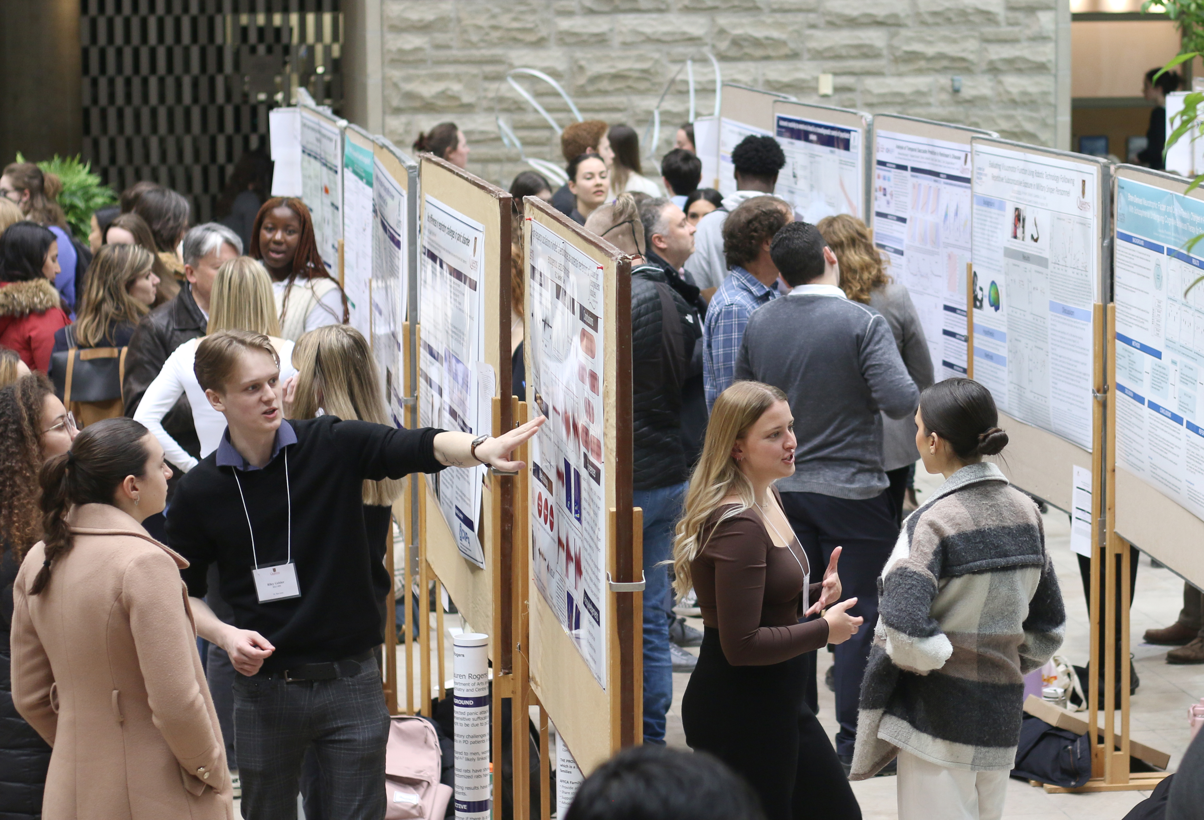 Wide angle image of students presenting their research posters in the Biosciences atrium