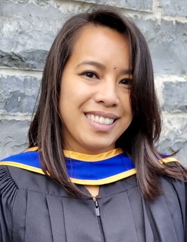 Headshot photo of Pearl Esquivel wearing a black graduation gown with blue and yellow convocation hood.